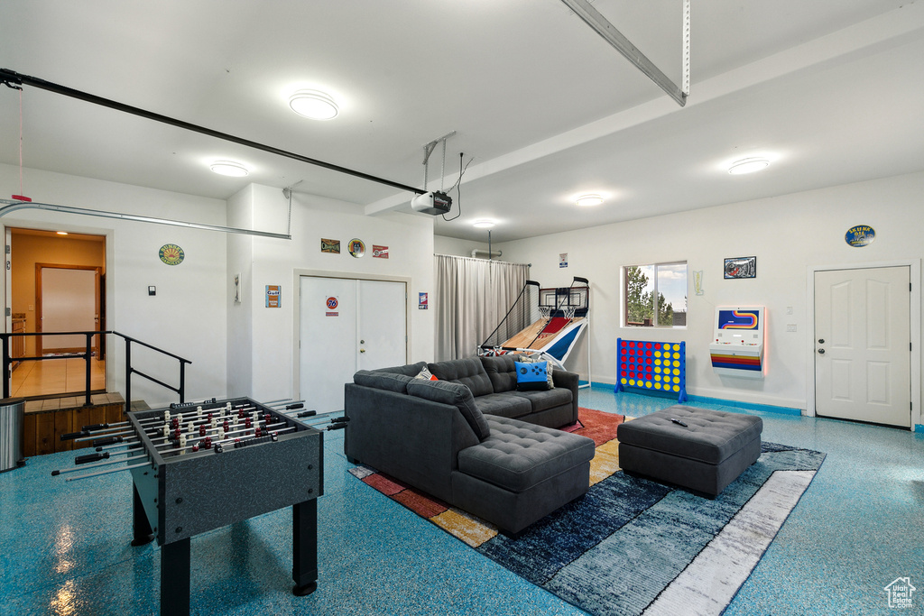 Playroom featuring speckle patterned floor and a garage