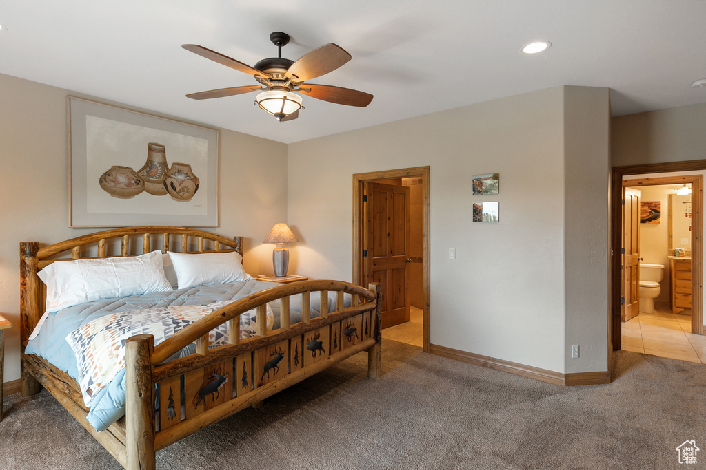 Bedroom featuring light carpet, ceiling fan, recessed lighting, and ensuite bath