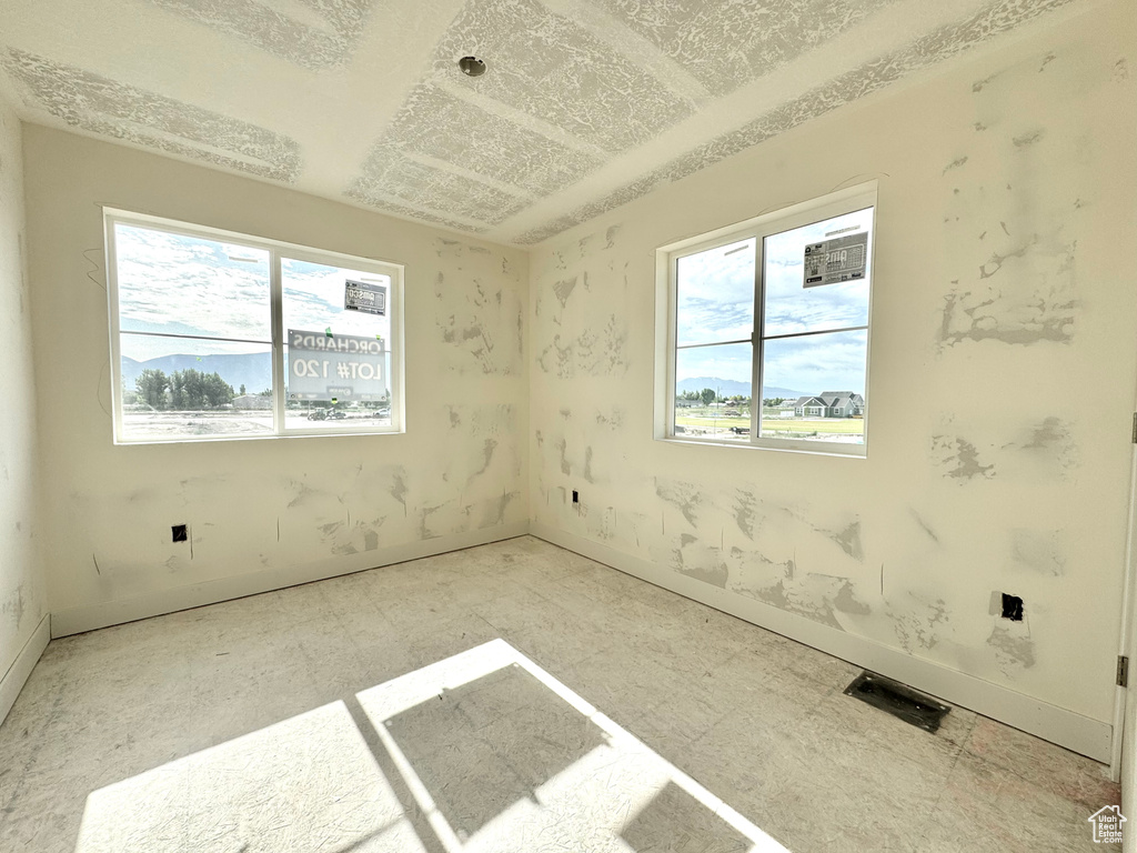 Unfurnished room with plenty of natural light