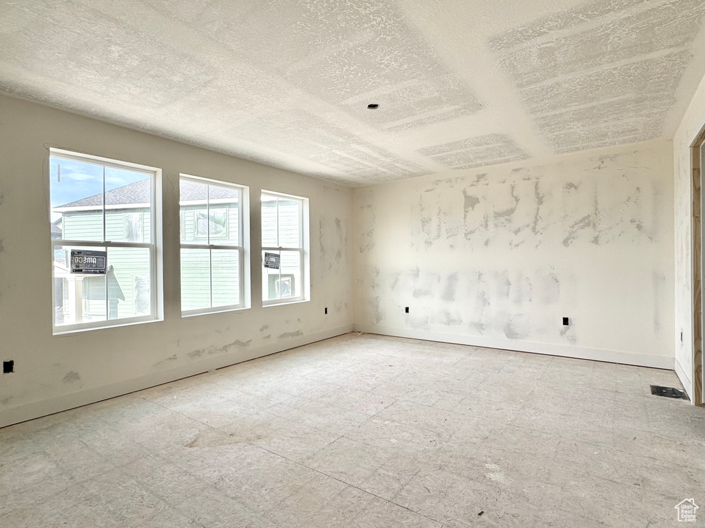 Empty room with a textured ceiling