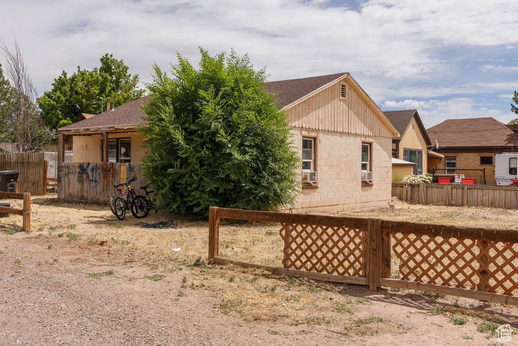Rear view of property with roof with shingles