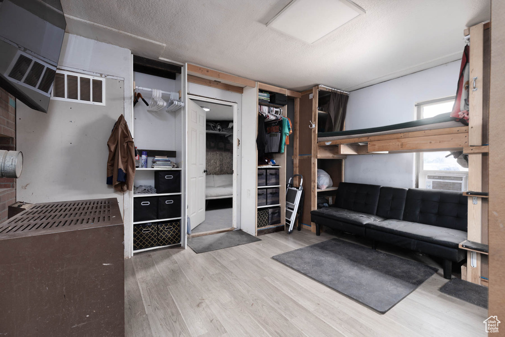 Spacious closet with wood finished floors and cooling unit