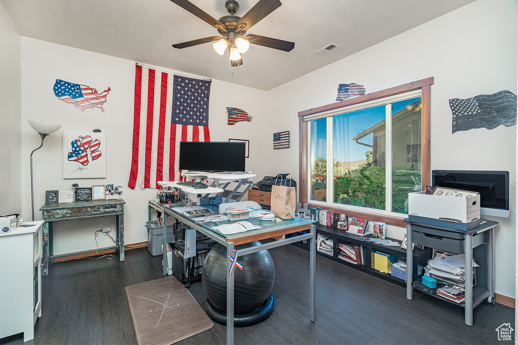 Office area featuring dark wood-style flooring and a ceiling fan