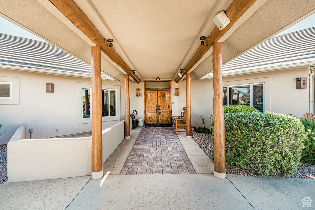View of exterior entry with stucco siding and french doors