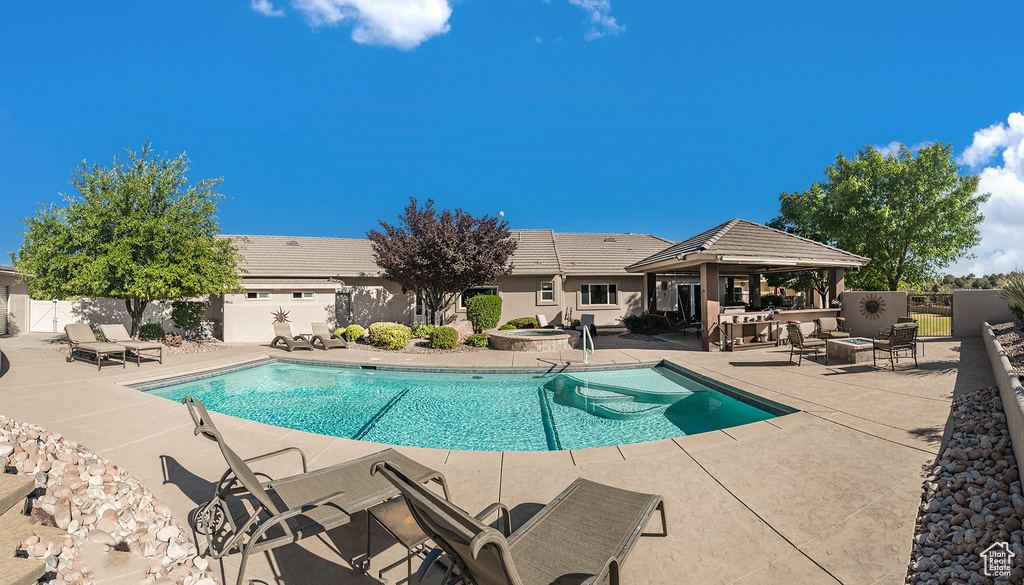 View of pool featuring a patio area, a fenced backyard, an in-ground hot tub, and a gazebo