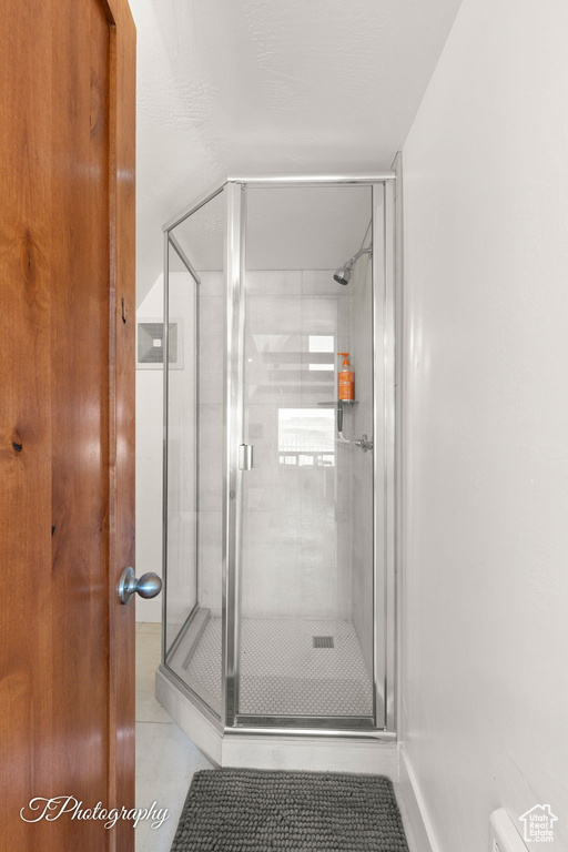 Full bath with a stall shower and tile patterned flooring