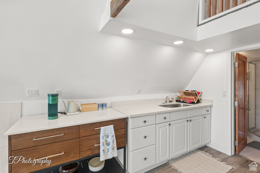 Kitchen with white cabinets, recessed lighting, light wood finished floors, and light countertops
