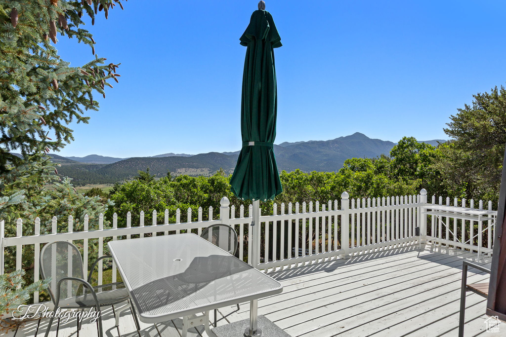 Wooden terrace featuring a mountain view