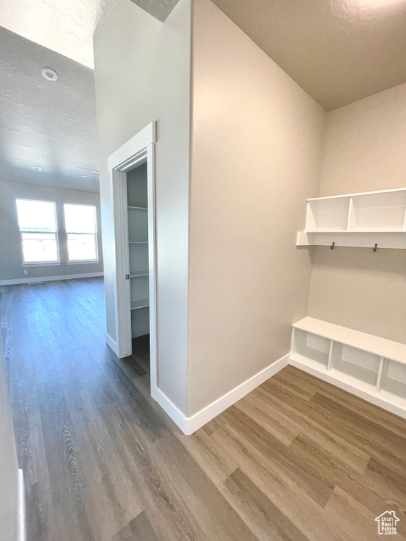 Mudroom featuring wood finished floors and a textured ceiling