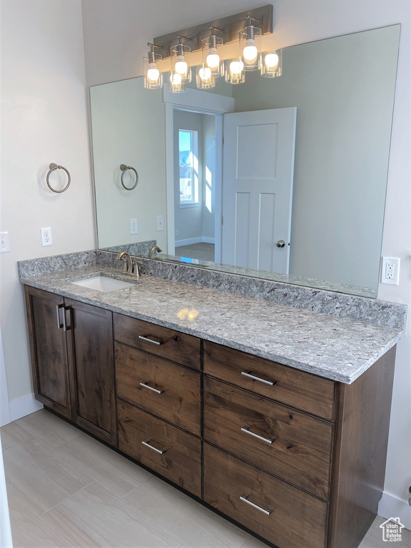 Bathroom with vanity and baseboards