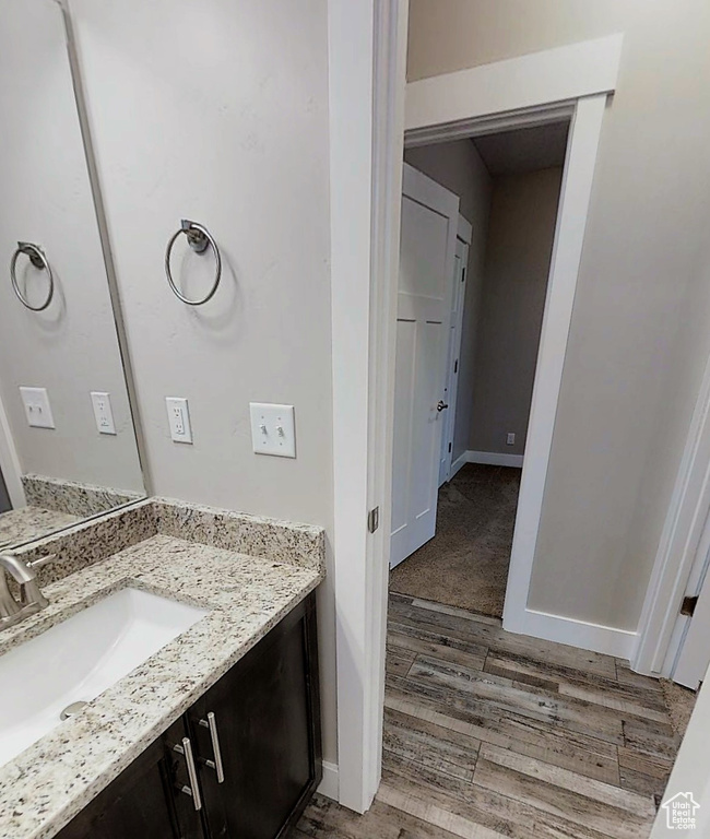 Bathroom featuring vanity and wood finished floors