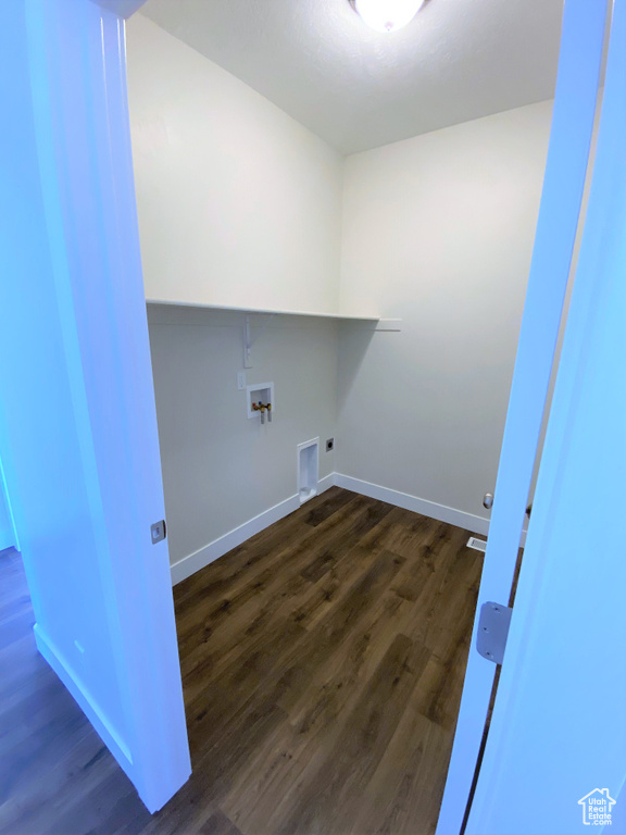 Laundry room featuring hookup for an electric dryer, dark wood finished floors, and washer hookup