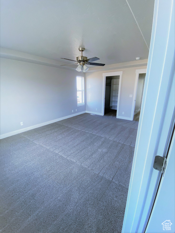 Unfurnished bedroom featuring carpet floors and ceiling fan