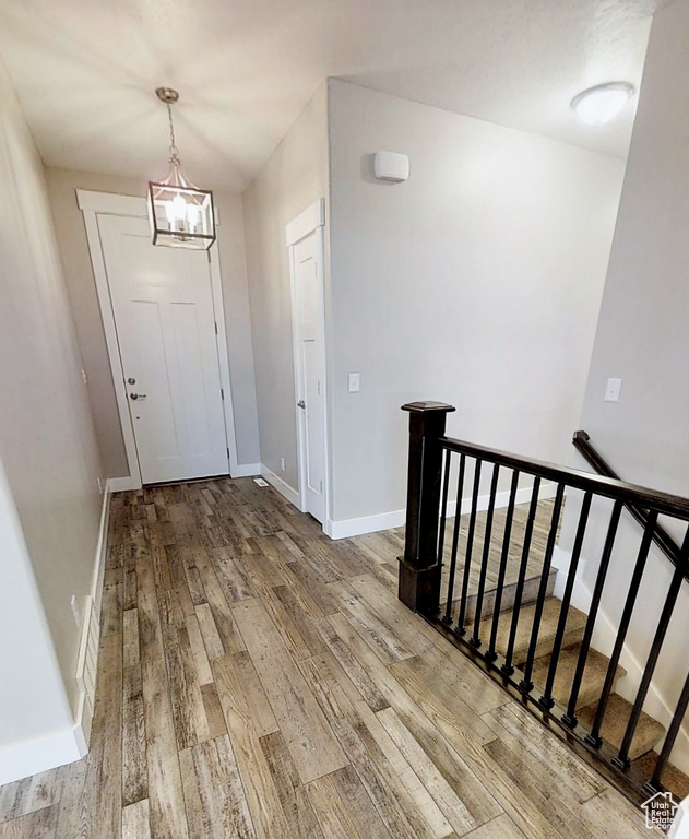 Entryway featuring hardwood / wood-style flooring and a chandelier