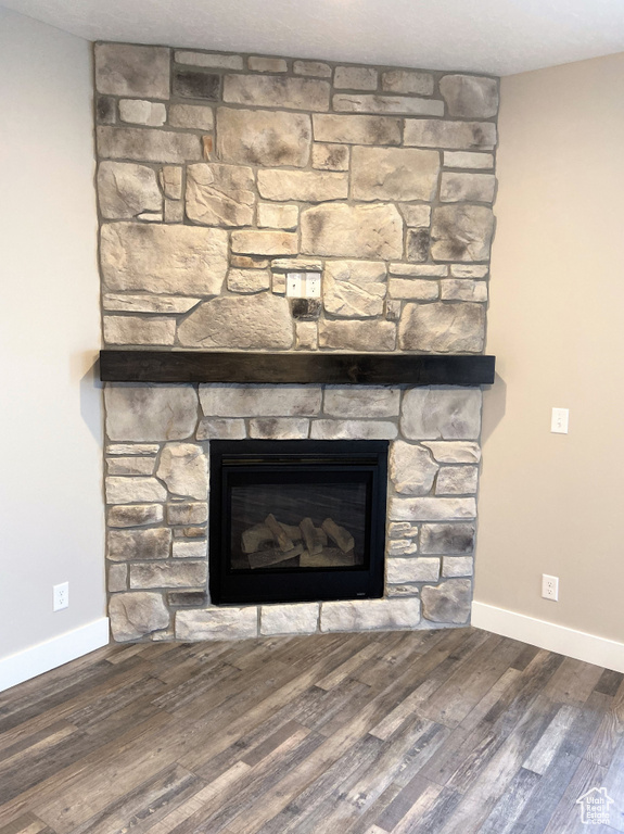Detailed view of a fireplace and wood finished floors