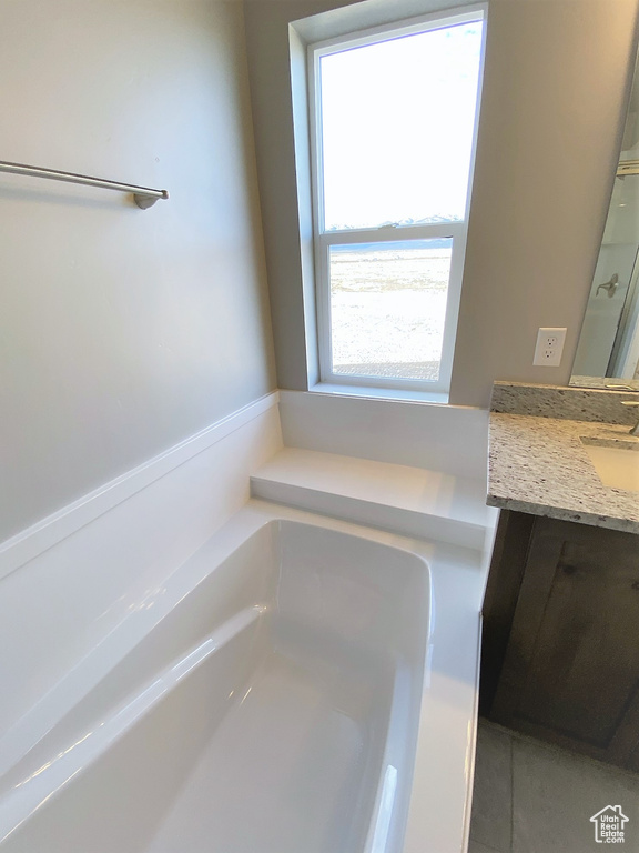 Full bathroom with vanity and a bath
