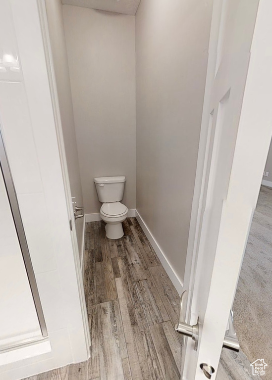 Bathroom featuring toilet and wood finished floors