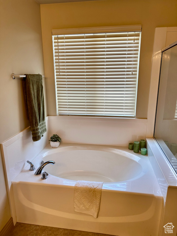 Bathroom featuring a bath and an enclosed shower