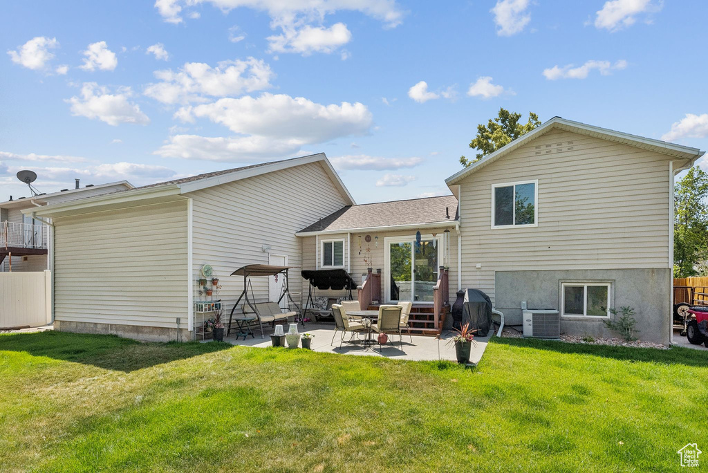 Back of property featuring a patio area and a lawn