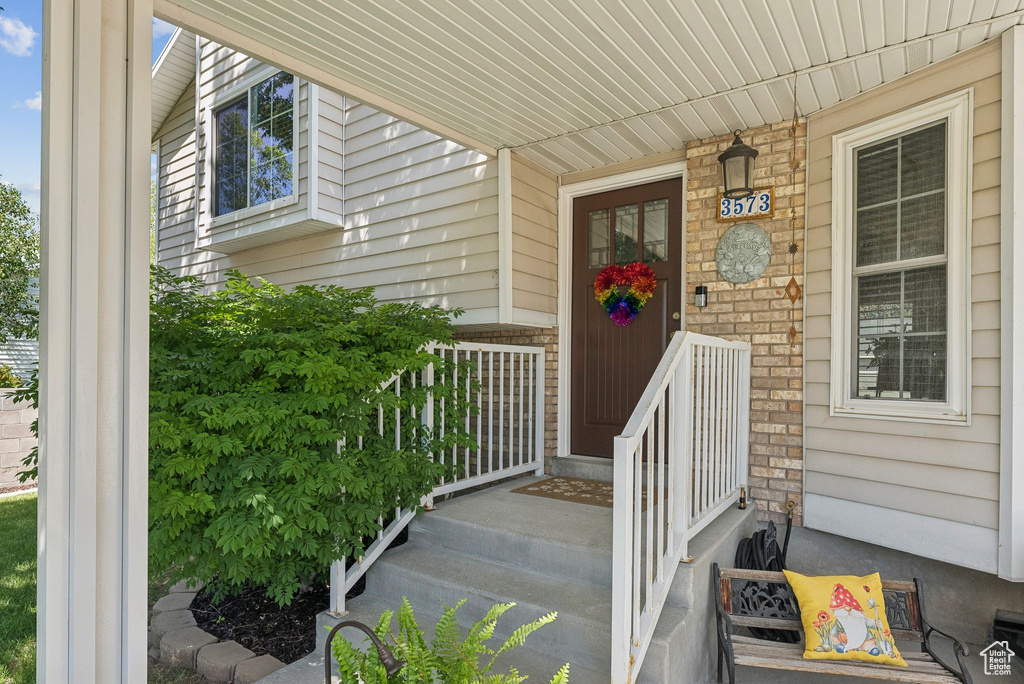 Property entrance featuring brick siding