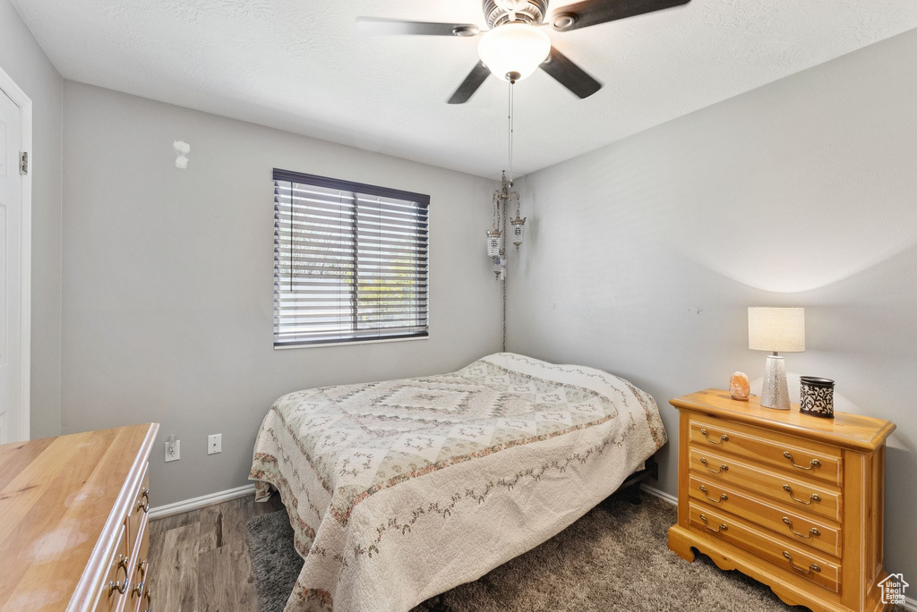 Bedroom with wood finished floors and a ceiling fan