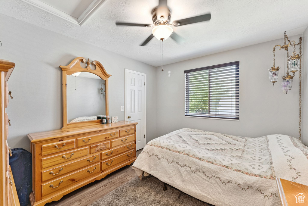 Bedroom featuring wood finished floors and a ceiling fan
