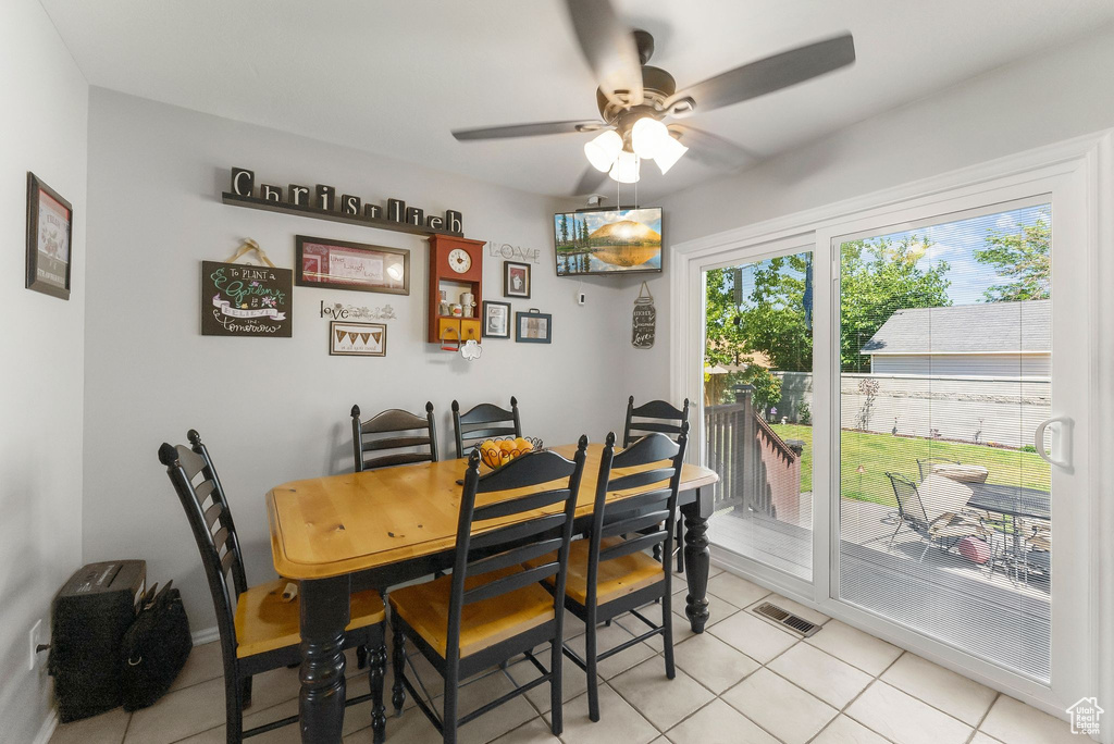 Dining area with ceiling fan and light tile patterned floors
