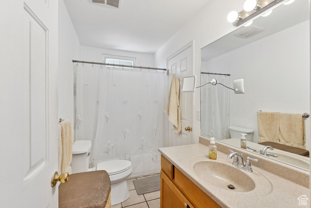 Bathroom featuring vanity and tile patterned flooring