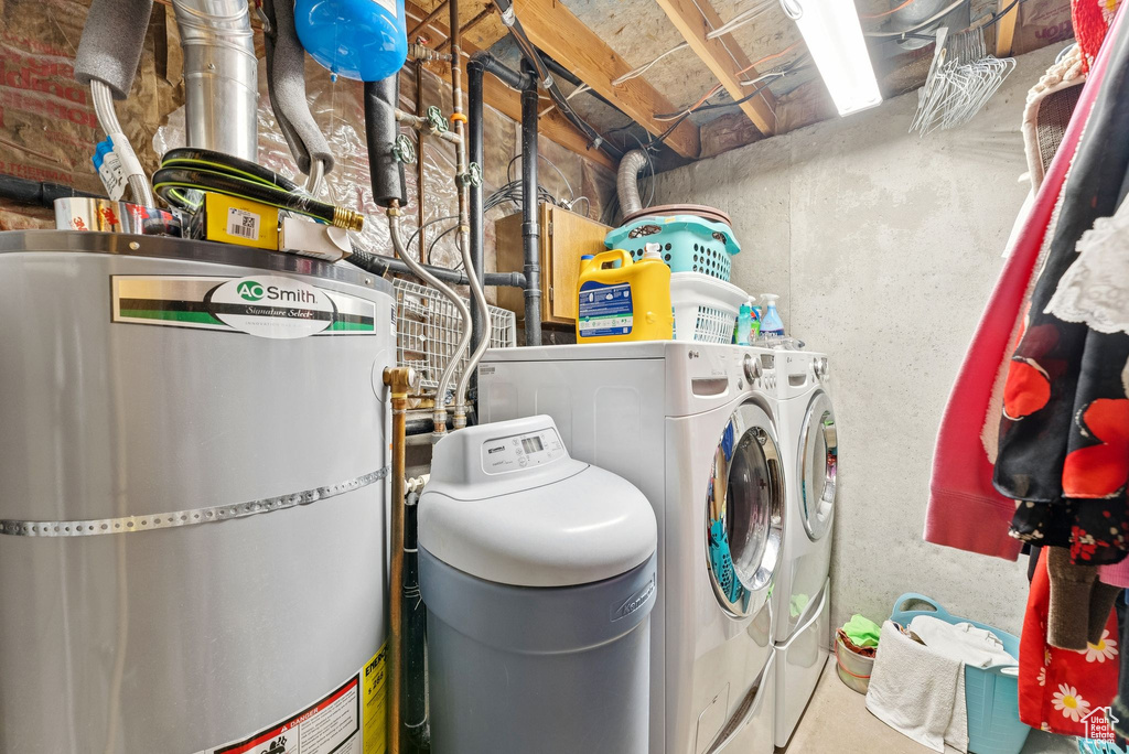 Washroom with strapped water heater and washing machine and dryer