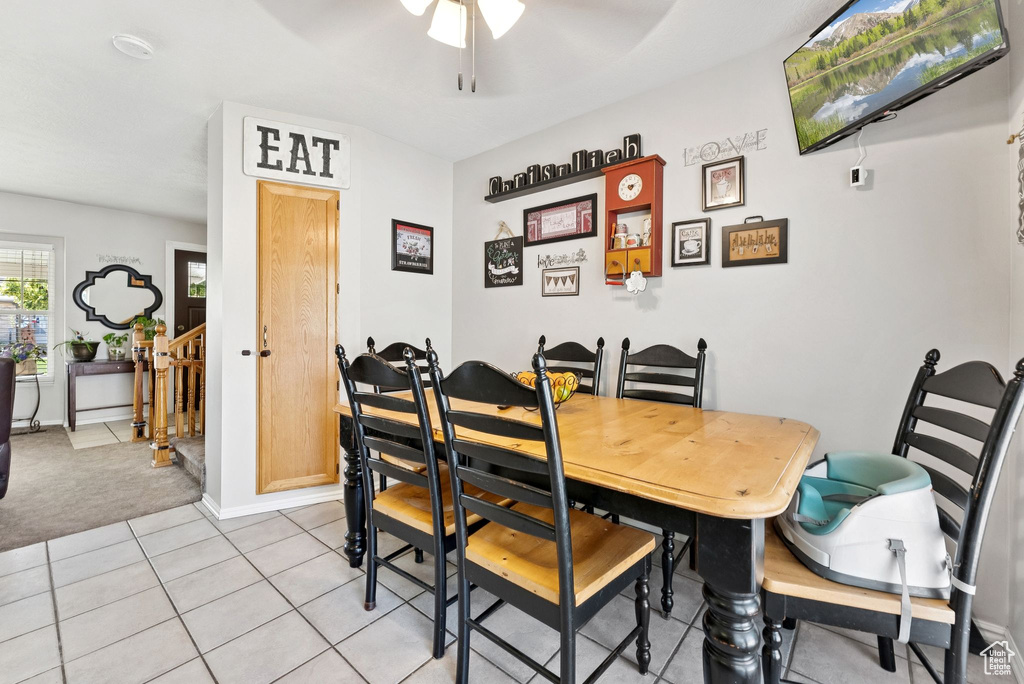 Dining area with ceiling fan and light tile patterned floors
