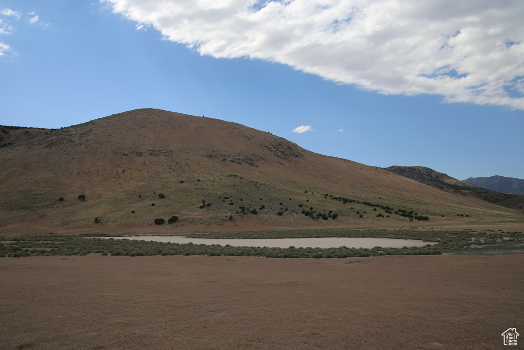 View of mountain backdrop featuring a nearby body of water