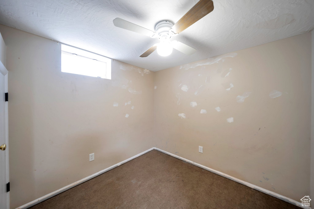 Spare room with carpet floors and ceiling fan