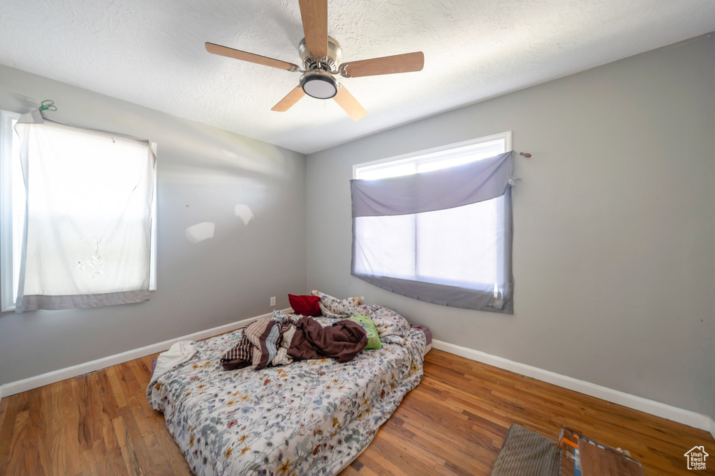 Bedroom featuring wood finished floors and a ceiling fan