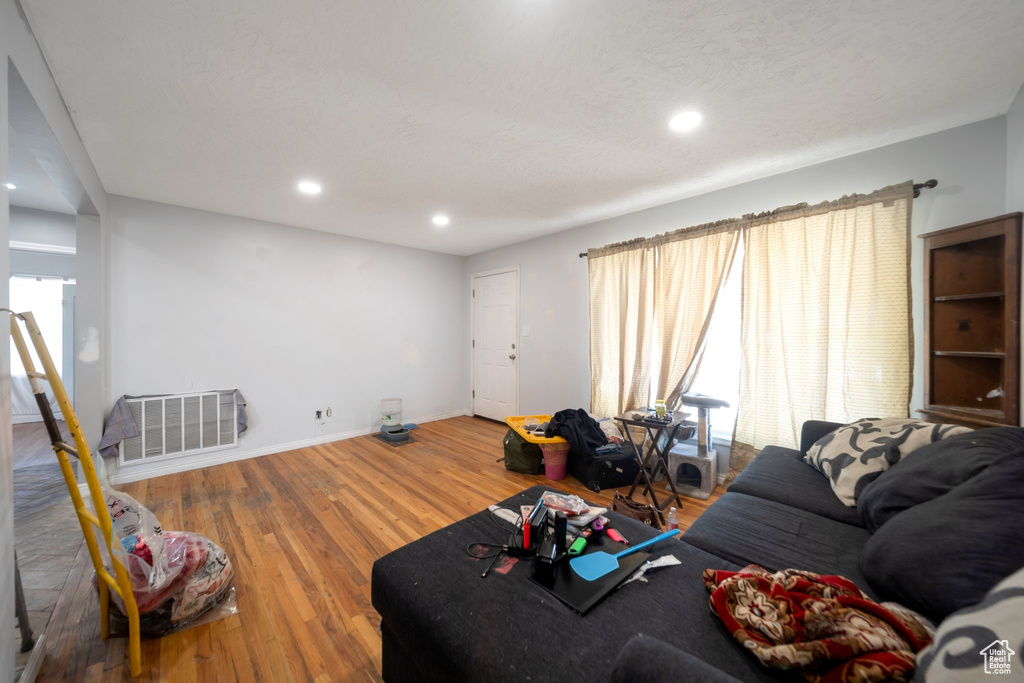 Living room with wood finished floors and recessed lighting