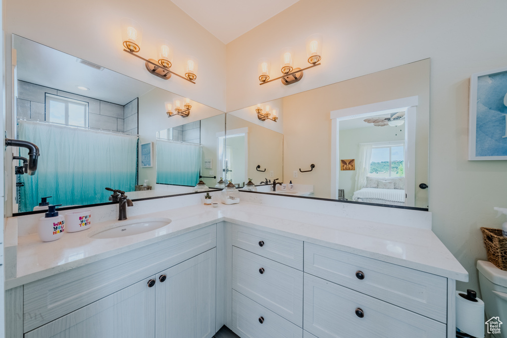 Ensuite bathroom with healthy amount of natural light and vanity
