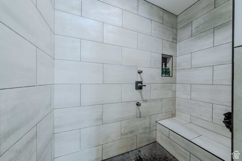 Full bath featuring a tile shower