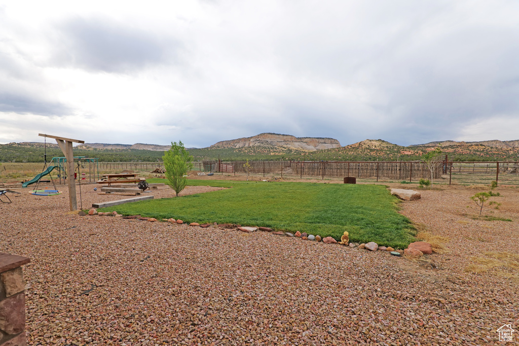 View of yard featuring a playground and a mountain view