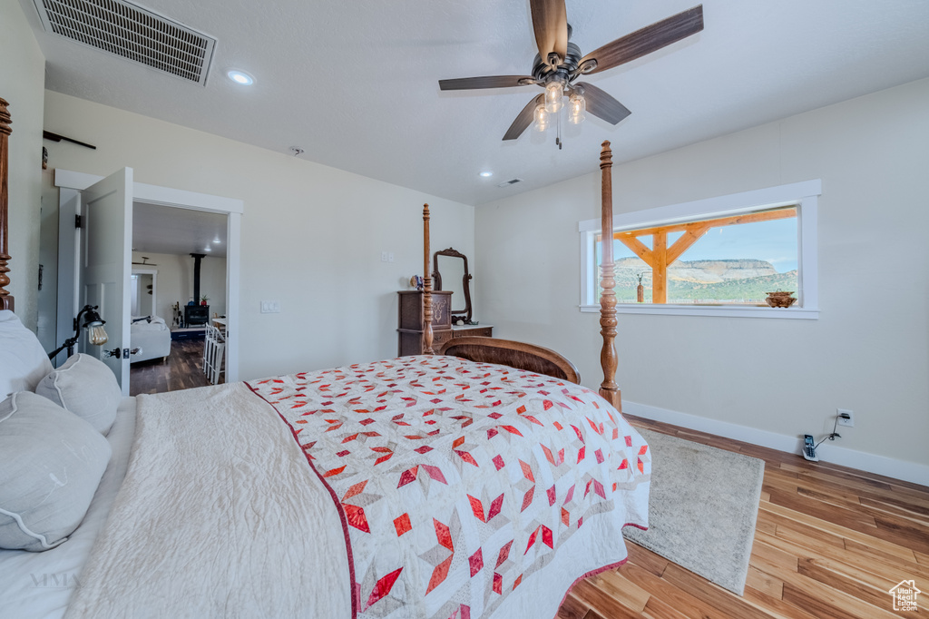 Bedroom featuring wood finished floors, recessed lighting, and ceiling fan