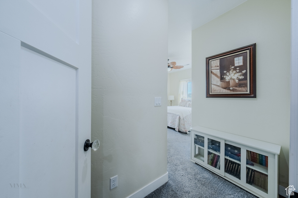 Corridor featuring carpet flooring
