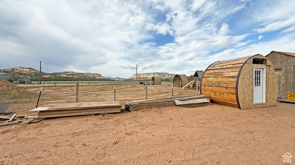 View of yard with a shed and a mountain view