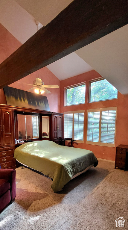 Bedroom with carpet flooring, high vaulted ceiling, and beam ceiling