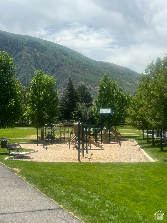 View of community with a mountain view and a lawn