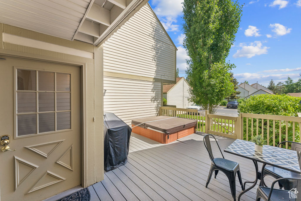 Deck featuring a grill and a covered hot tub