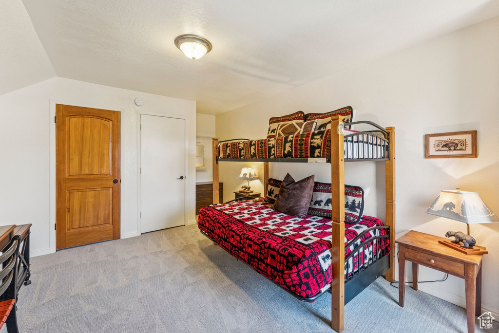 Bedroom featuring carpet flooring and baseboards
