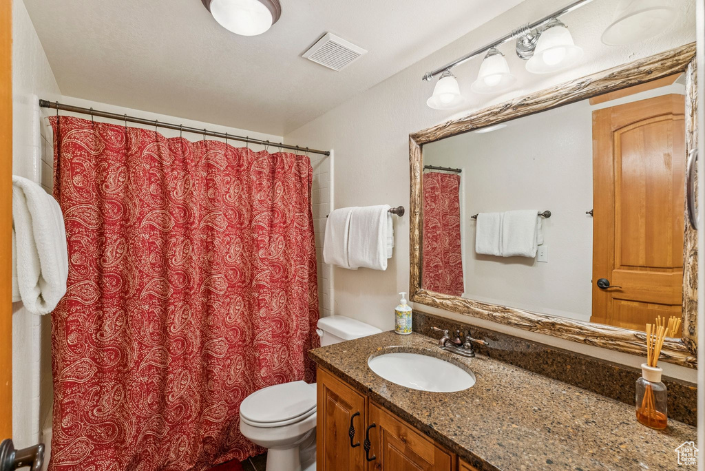 Full bathroom with vanity and curtained shower