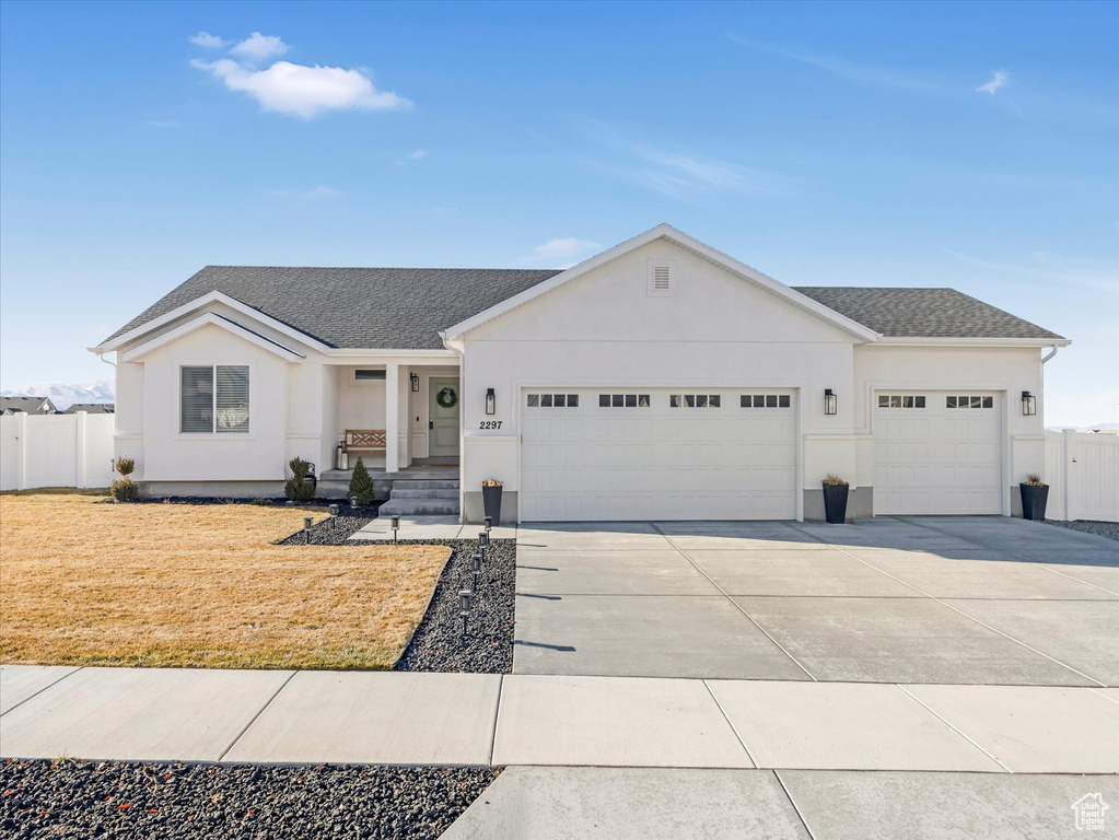 Ranch-style house featuring a garage, stucco siding, concrete driveway, and a shingled roof