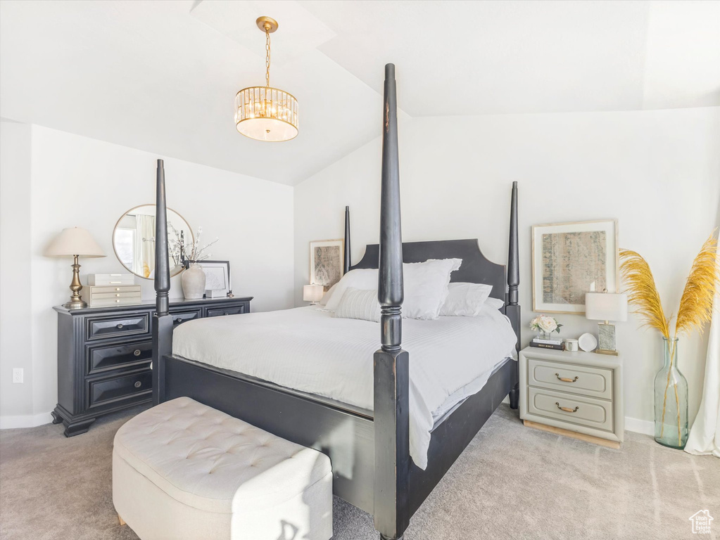 Carpeted bedroom featuring vaulted ceiling and baseboards
