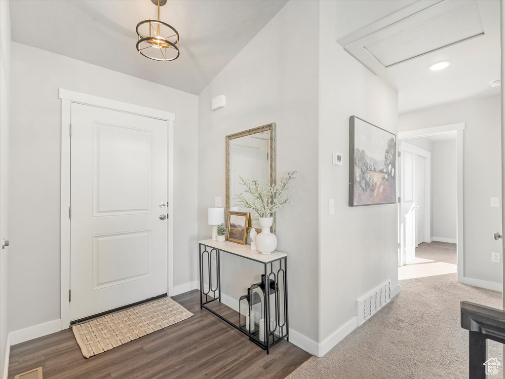 Entrance foyer featuring baseboards and dark wood-style flooring