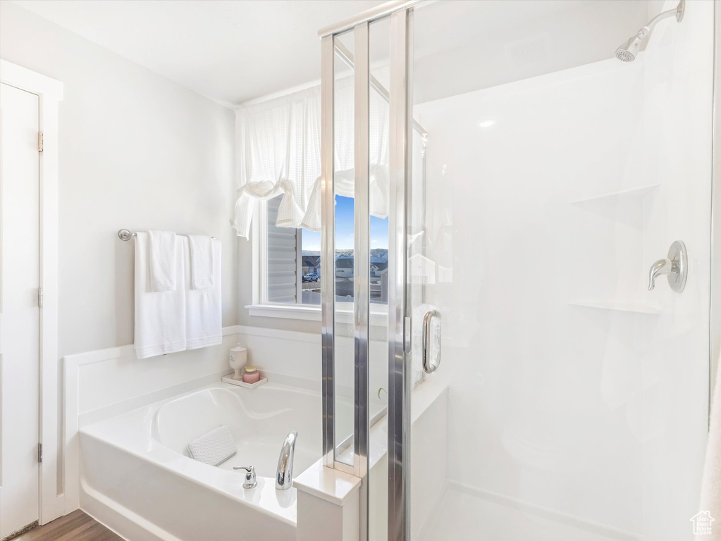 Full bathroom with a stall shower and a bath