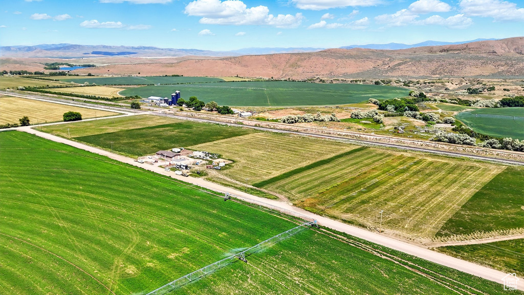 View of rural area featuring a water and mountain view and rows of crops